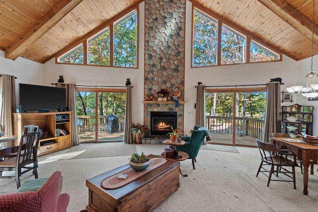 carpeted living room featuring high vaulted ceiling, a fireplace, and wooden ceiling