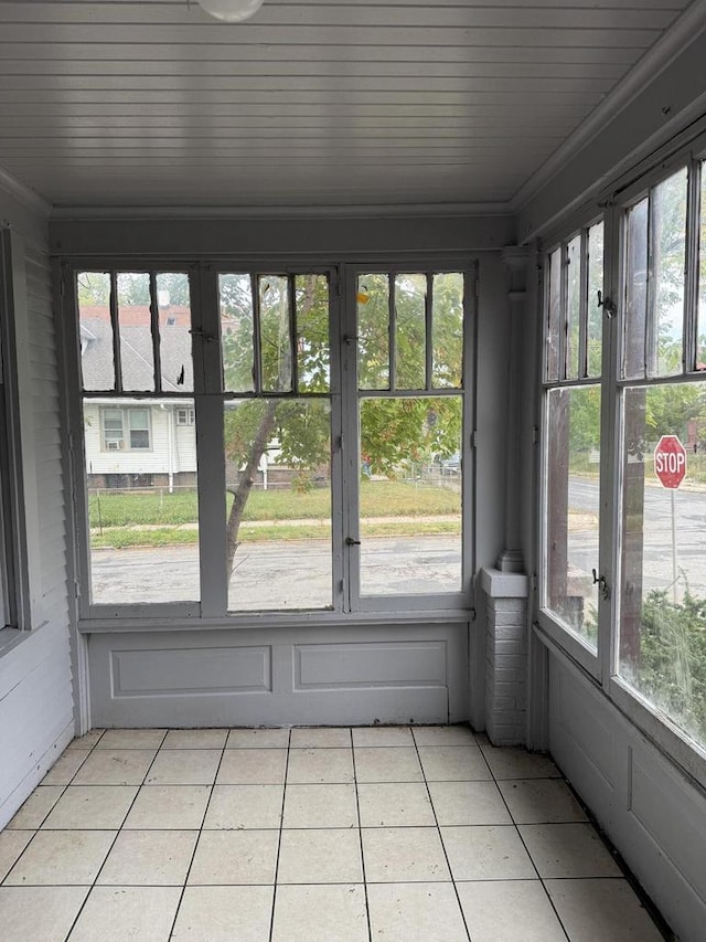 unfurnished sunroom with wood ceiling and a healthy amount of sunlight