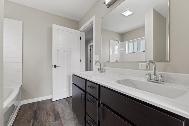 bathroom with wood-type flooring, shower / tub combination, and vanity