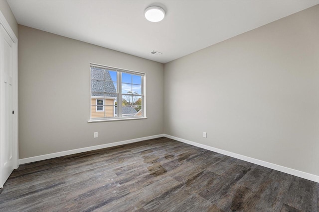 empty room featuring dark hardwood / wood-style floors