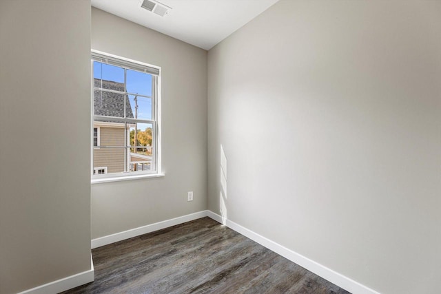 unfurnished room with dark wood-type flooring