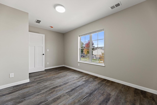 unfurnished room with dark hardwood / wood-style flooring