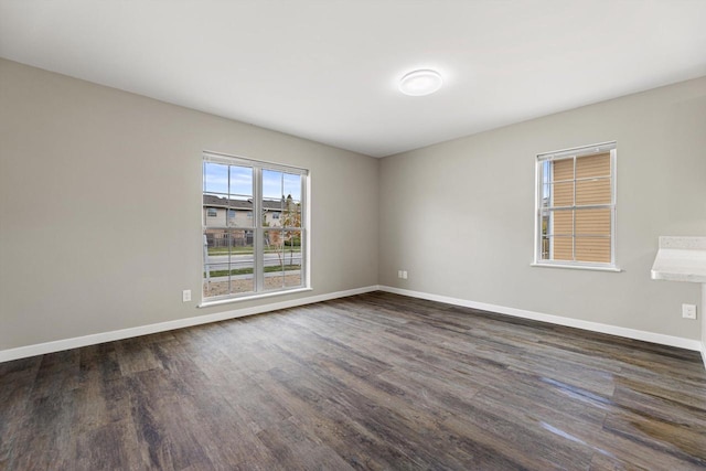 empty room with dark wood-type flooring