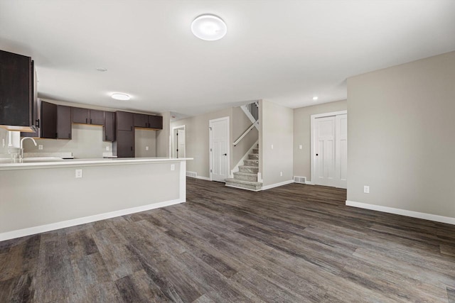 kitchen featuring dark brown cabinets, sink, and dark hardwood / wood-style flooring