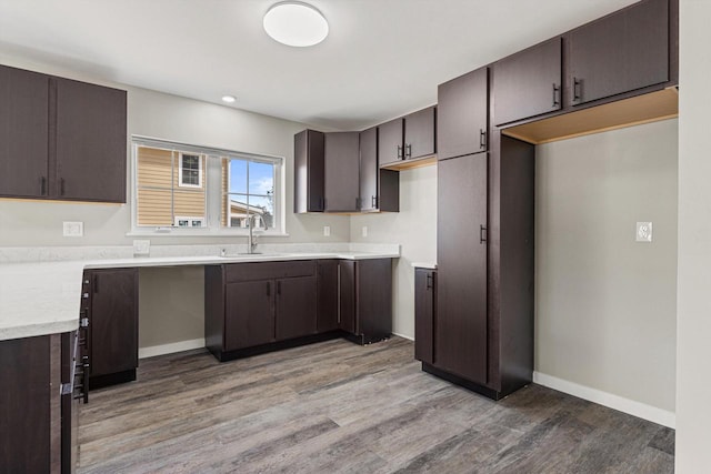 kitchen featuring light hardwood / wood-style floors, sink, and dark brown cabinets