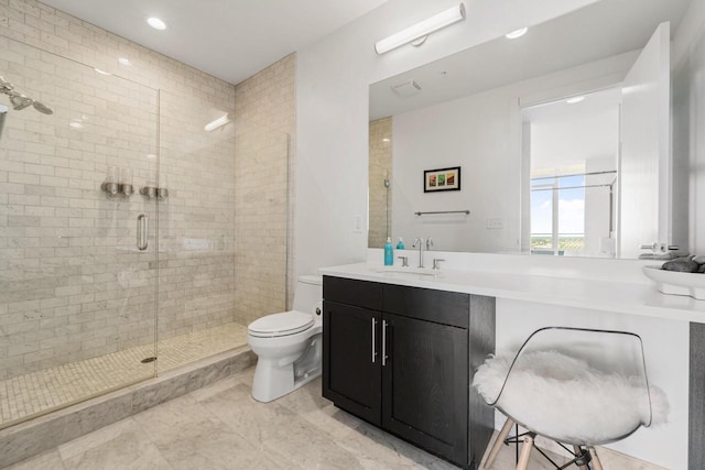 bathroom with walk in shower, vanity, and toilet