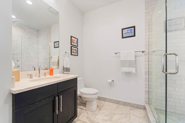 full bathroom with toilet, a stall shower, baseboards, and vanity