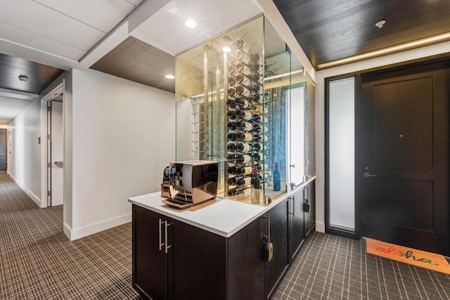 wine cellar featuring baseboards, recessed lighting, and carpet flooring