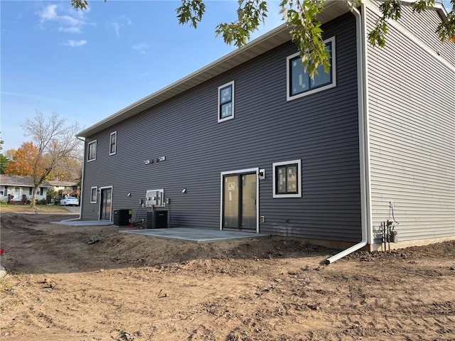 back of house with a patio and central AC