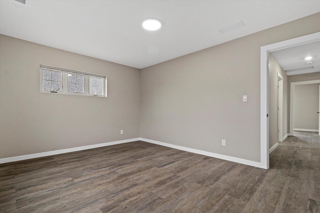 spare room with dark hardwood / wood-style flooring