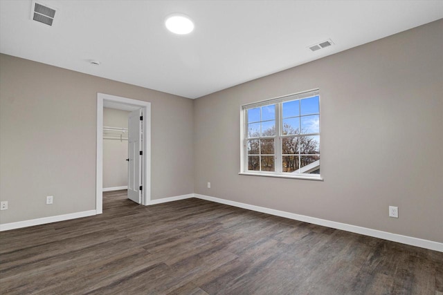 empty room with dark hardwood / wood-style floors