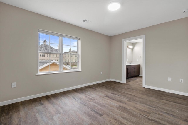 spare room with wood-type flooring