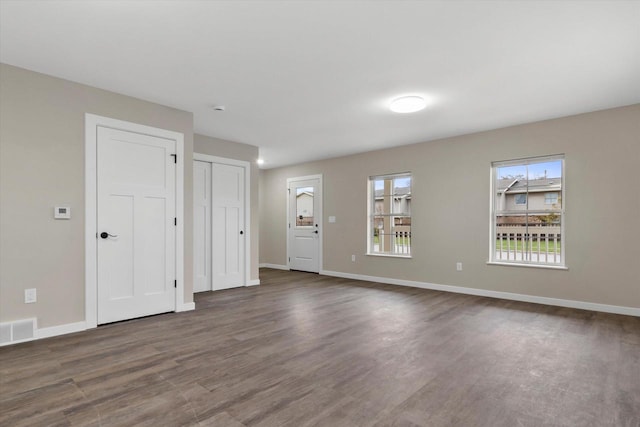 spare room featuring dark wood-type flooring