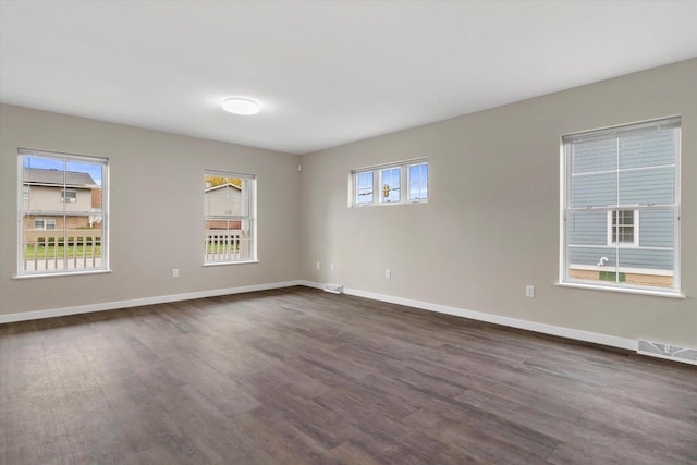 empty room with dark wood-type flooring