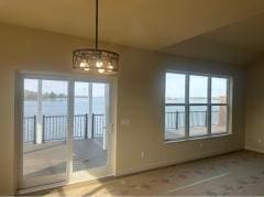 unfurnished dining area with a notable chandelier, a water view, and a wealth of natural light