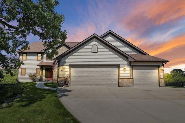 view of front of home with a garage and a yard