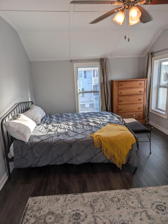 bedroom with ceiling fan, lofted ceiling, and dark hardwood / wood-style flooring