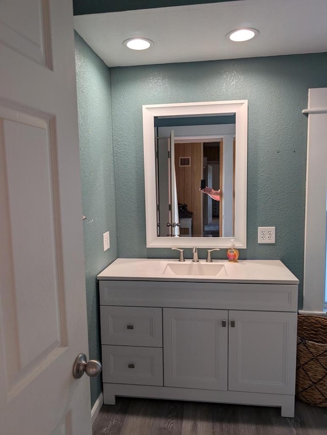 bathroom with vanity and hardwood / wood-style floors