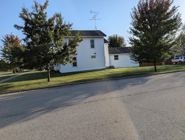 view of side of property with a yard