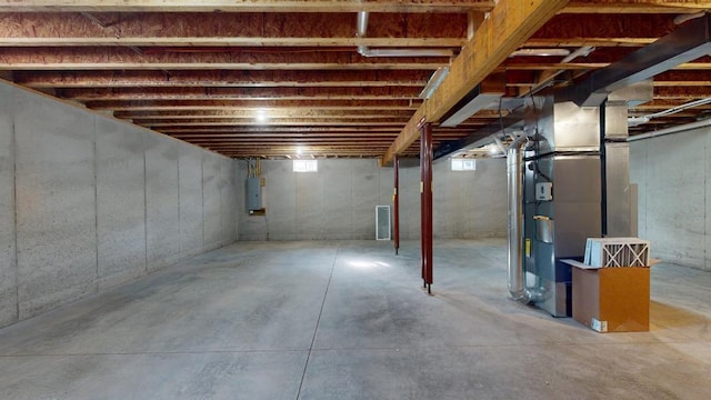 basement with electric panel and heating unit