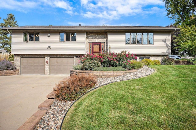 bi-level home with a garage and a front yard