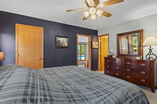 bedroom with ceiling fan, carpet floors, and multiple windows