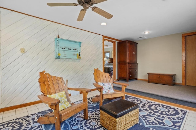 sitting room featuring light tile patterned flooring and ceiling fan