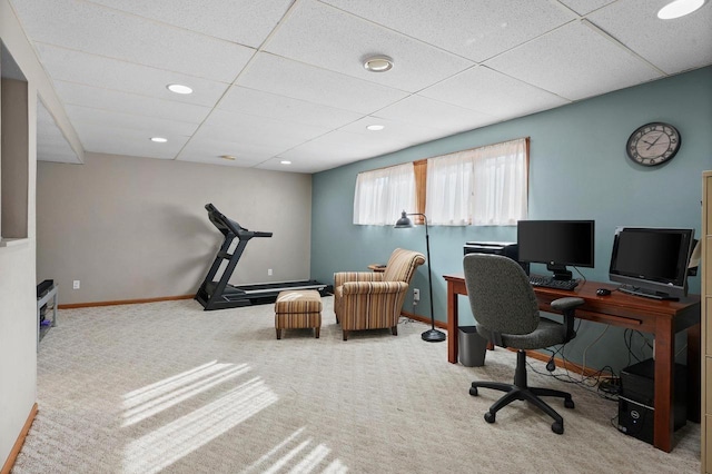 carpeted office space featuring a drop ceiling