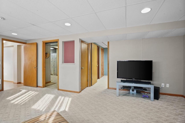 basement featuring a paneled ceiling and carpet floors