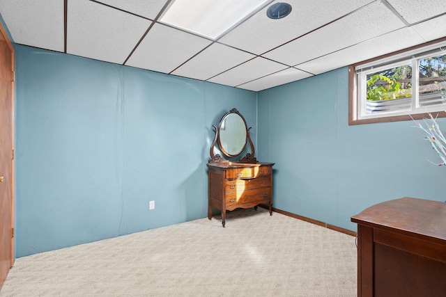 office space featuring light colored carpet and a paneled ceiling