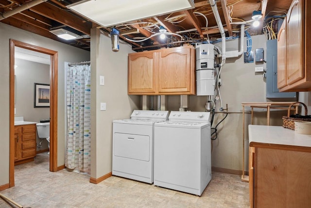 washroom featuring washer and dryer and cabinets