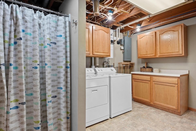 clothes washing area with cabinets, electric panel, and washing machine and dryer