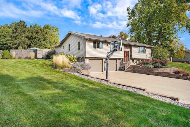 bi-level home featuring a front yard and a garage