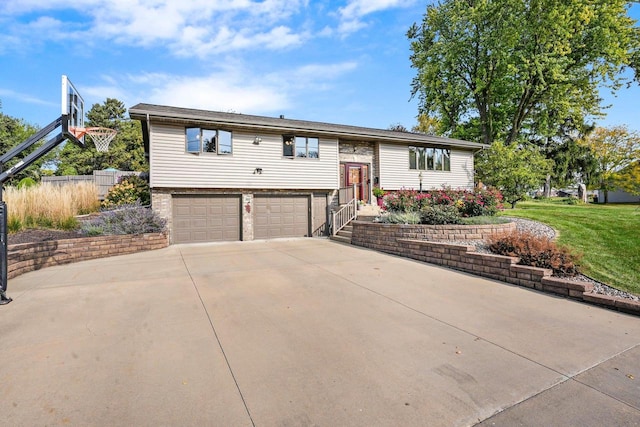 bi-level home with a garage and a front lawn