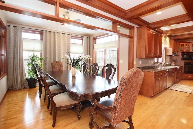 dining space with light hardwood / wood-style floors, beam ceiling, and plenty of natural light