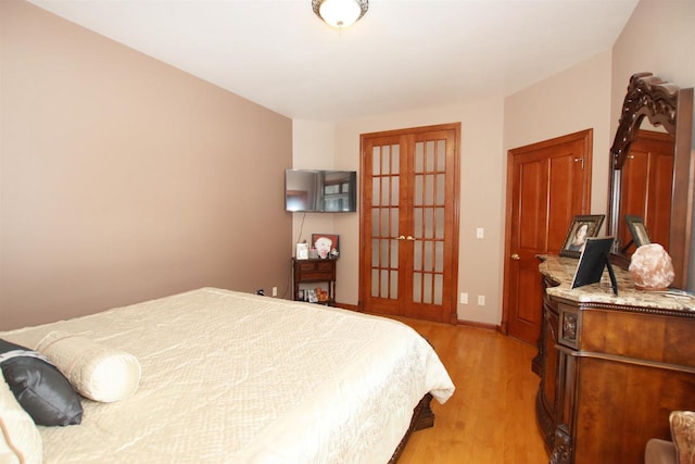 bedroom with light hardwood / wood-style flooring and french doors