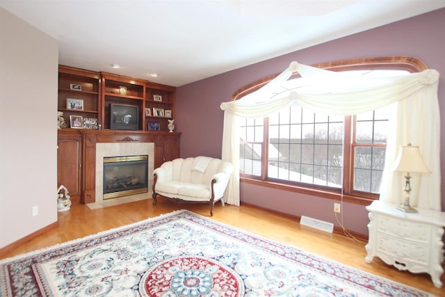 living area with a fireplace and light wood-type flooring