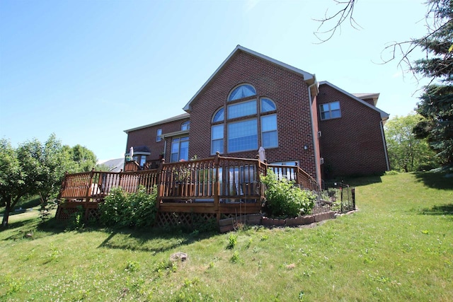 back of property featuring a yard and a wooden deck