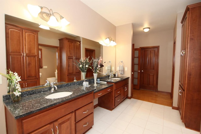 bathroom with vanity, toilet, and hardwood / wood-style floors