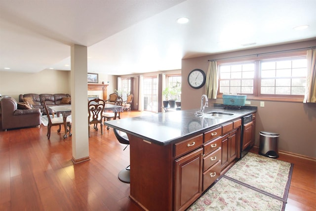 kitchen featuring sink, a breakfast bar area, and dark hardwood / wood-style flooring