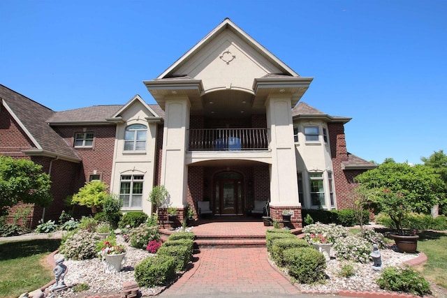 view of front of property featuring french doors and a balcony