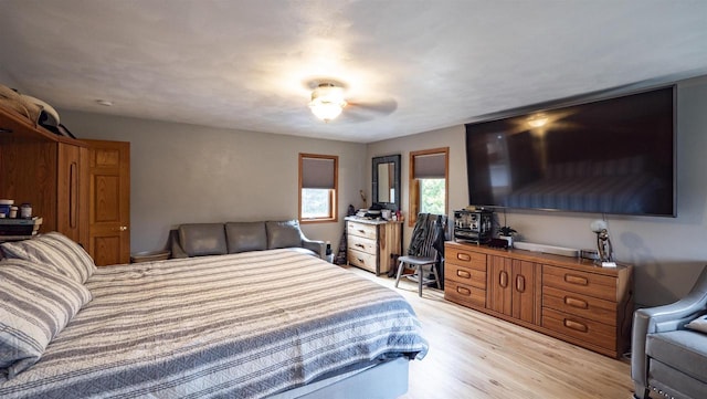 bedroom featuring light wood-type flooring and ceiling fan