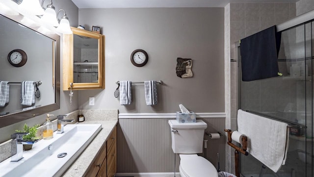 bathroom with an enclosed shower, vanity, and toilet