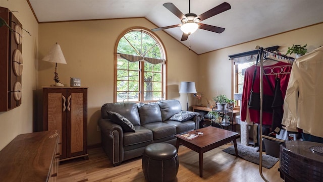 living room with ceiling fan, light hardwood / wood-style flooring, and lofted ceiling