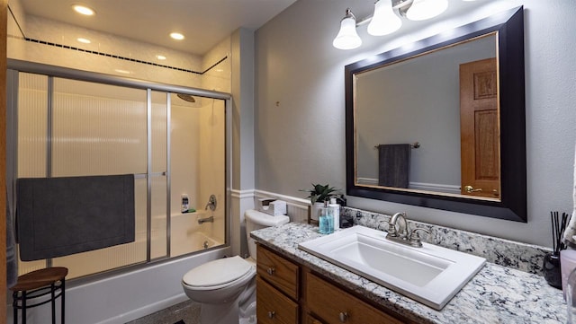 full bathroom with shower / bath combination with glass door, vanity, and toilet