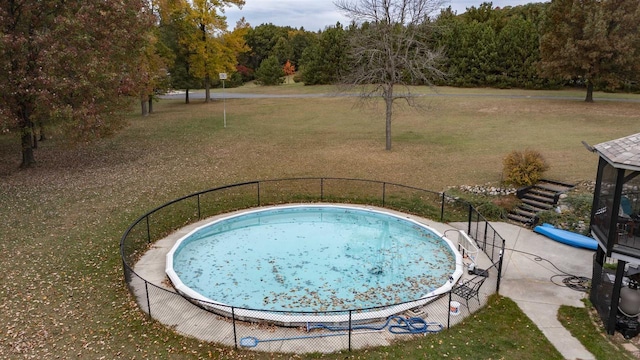 view of pool featuring a yard