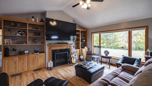 living room featuring ceiling fan, vaulted ceiling, and light hardwood / wood-style floors