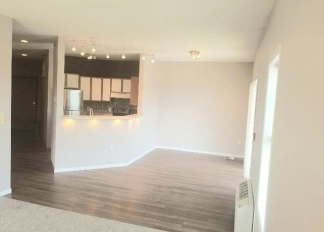 unfurnished living room with hardwood / wood-style floors