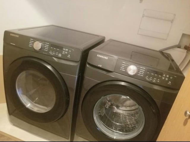 clothes washing area with washer and dryer