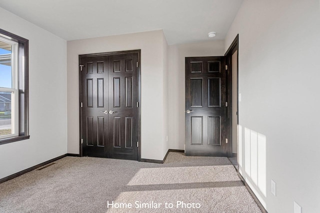 view of carpeted foyer entrance